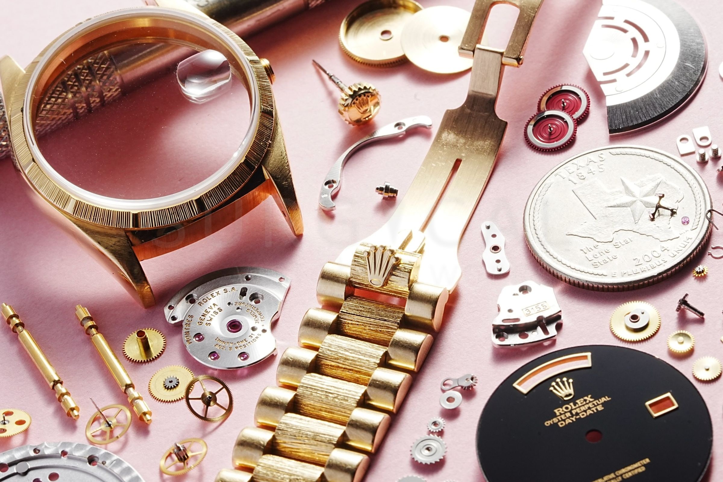 18k Rolex Day-Date fully disassembled on the bench